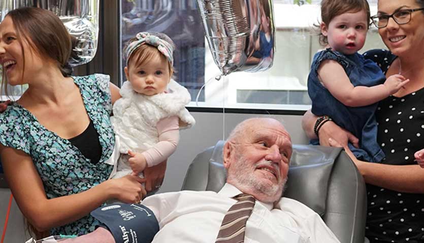 James Harrison, pictured above surrounded by mothers of Anti-D babies at his final donation. (from left to right): Christine Damiandis and Georgio, Michelle Dibbs and Eloise, Tanya McLaren and Brianna, Sarah Doyle and Grace. Credit Steven Siewert
