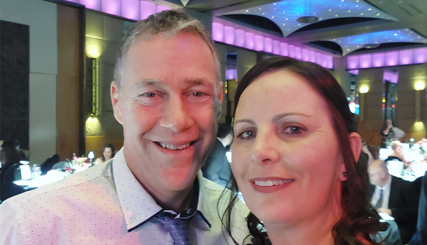 A couple posing for a selfie at a party 