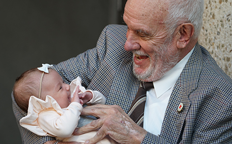 photo of a man called James Harrison holding a young baby