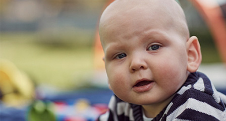 a baby looking at the camera