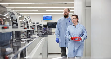 two scientists walking through a laboratory