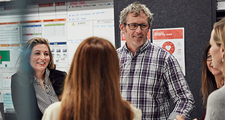 a group of people in an office setting having a discussion