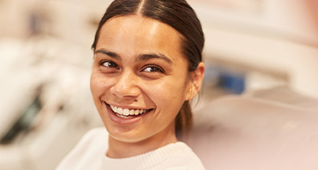 a woman in a donor chair smiling