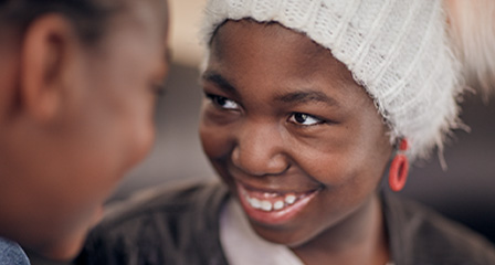 close up of two children smiling at one another