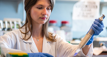 a scientist in a lab looking at a sample