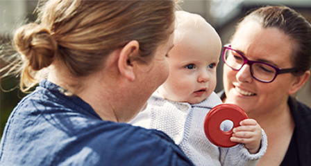 parents with a baby smiling