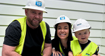 a family of three all wearing high vis and hardhats
