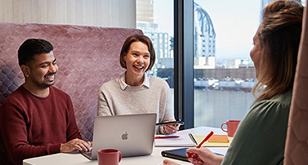 three people in an office having a meeting