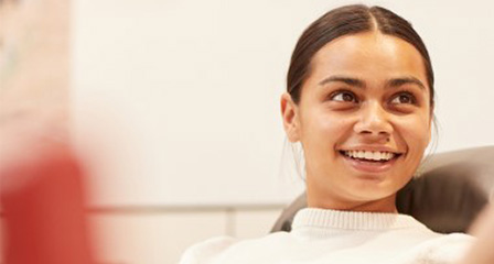 a woman in a donor chair smiling