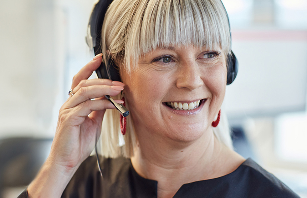 a woman with a phone headset smiling