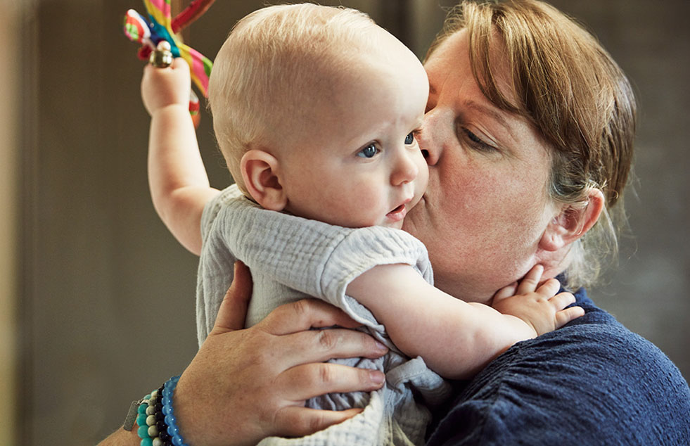a mother holding her baby