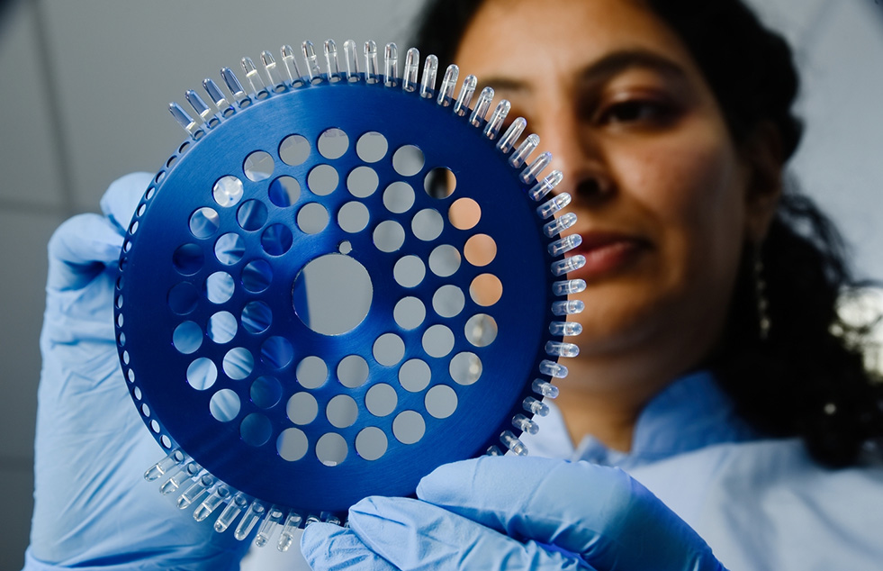 a scientist is holding up some samples