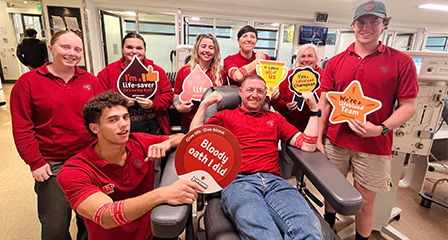 a group of people in a donor centre smiling at the camera