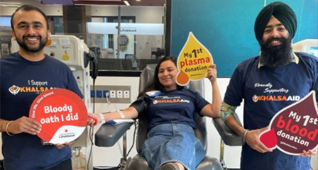 three people in a donor centre smiling to camera