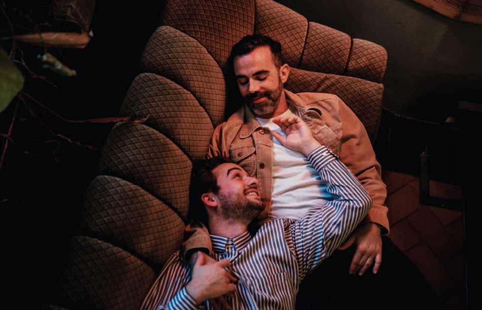 a male couple lying on a couch