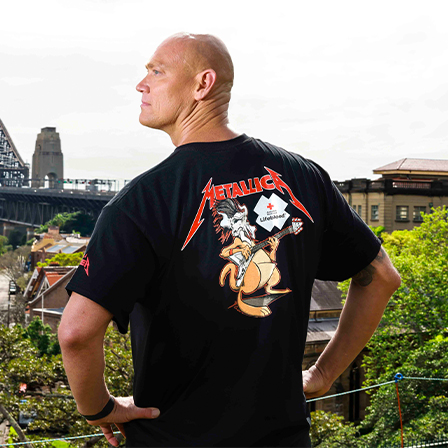 Michael Klim wearing the Lifeblood and Metallica collab t-shirt looking towards the Sydney harbour bridge
