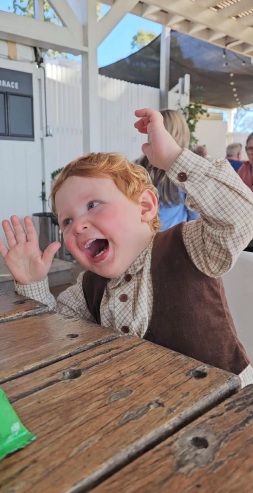 happy child with red hair pulling a funny face
