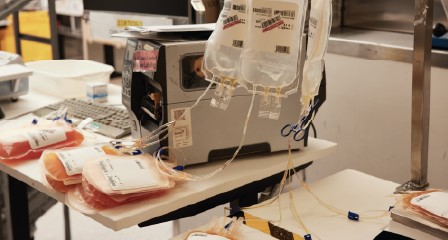 bags of blood components on a desk in front of lab machine