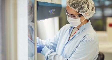 a scientist in a lab looking at a sample