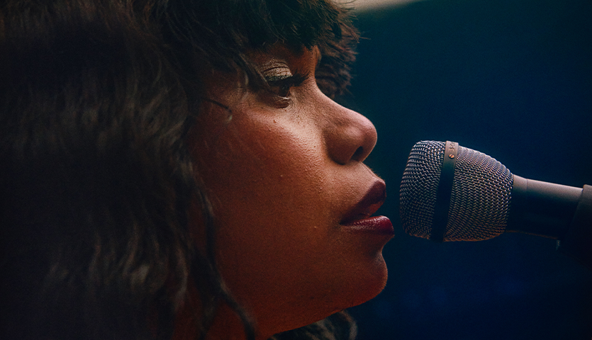 Woman singing into microphone