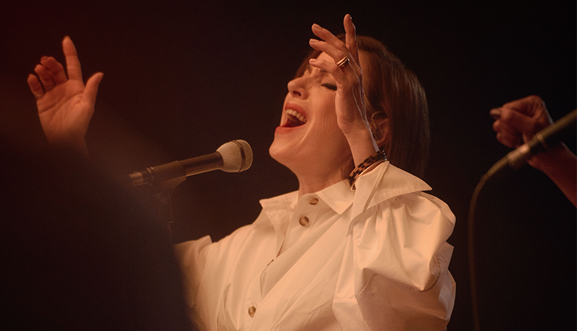 Woman signing into microphone 