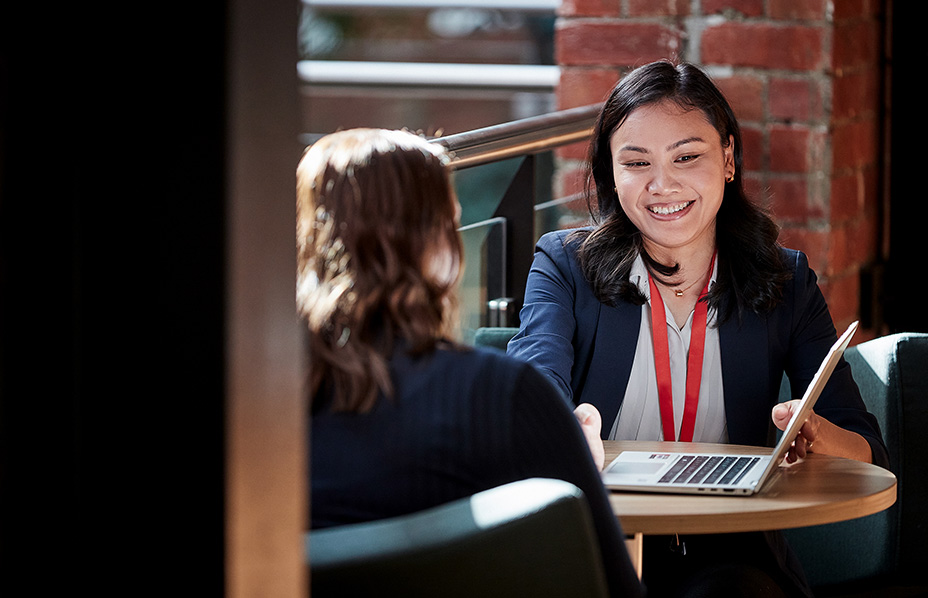 photograph of doctor in front of a computer speaking to patient
