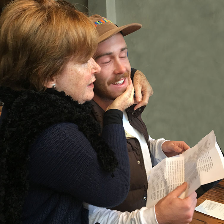 man and woman seated at a restaurant table smiling at camera