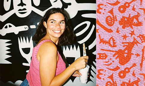 artist aretha brown smiling and holding a paintbrush