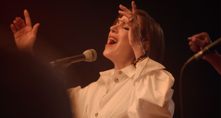 Woman signing into microphone 