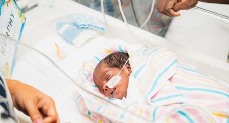 premature baby in crib in hospital