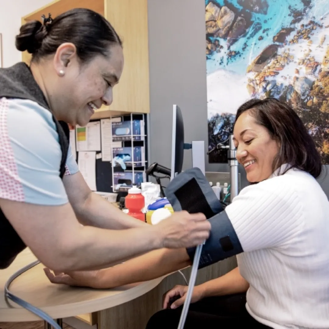 a person having their blood pressure taken by a staff member