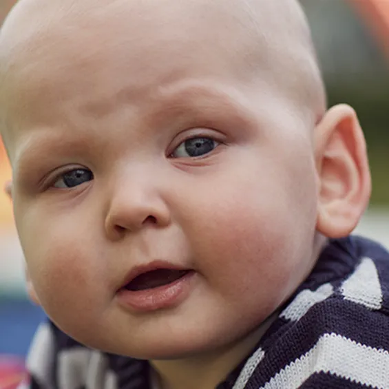 a baby looking at the camera