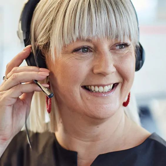 a woman with a phone headset smiling