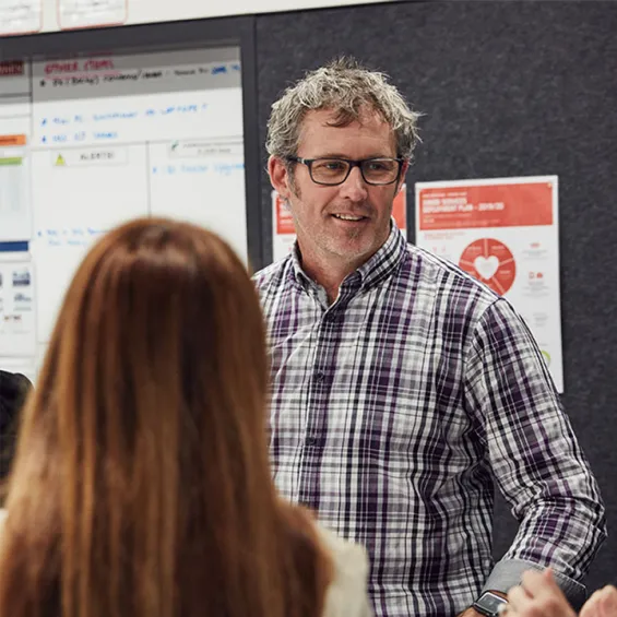 a group of people in an office setting having a discussion