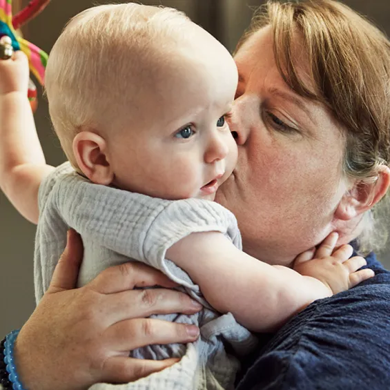 a mother hugging her baby