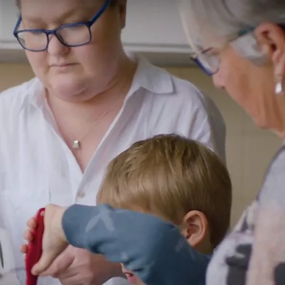 Organ donation recipient Miranda in the kitchen with her family.
