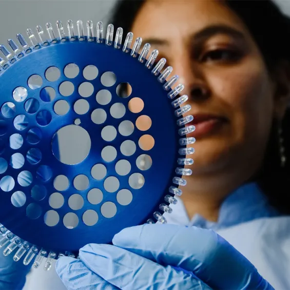a scientist is holding up some samples