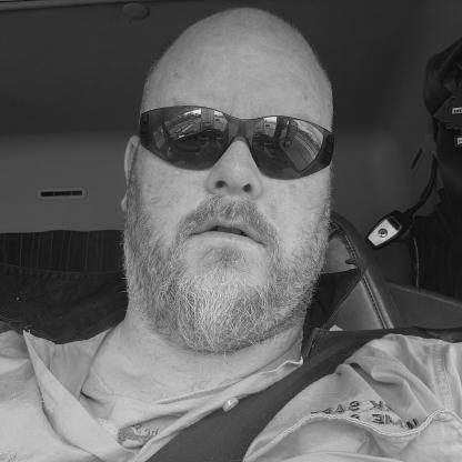man sitting in his car, wearing hi vis taking a selfie